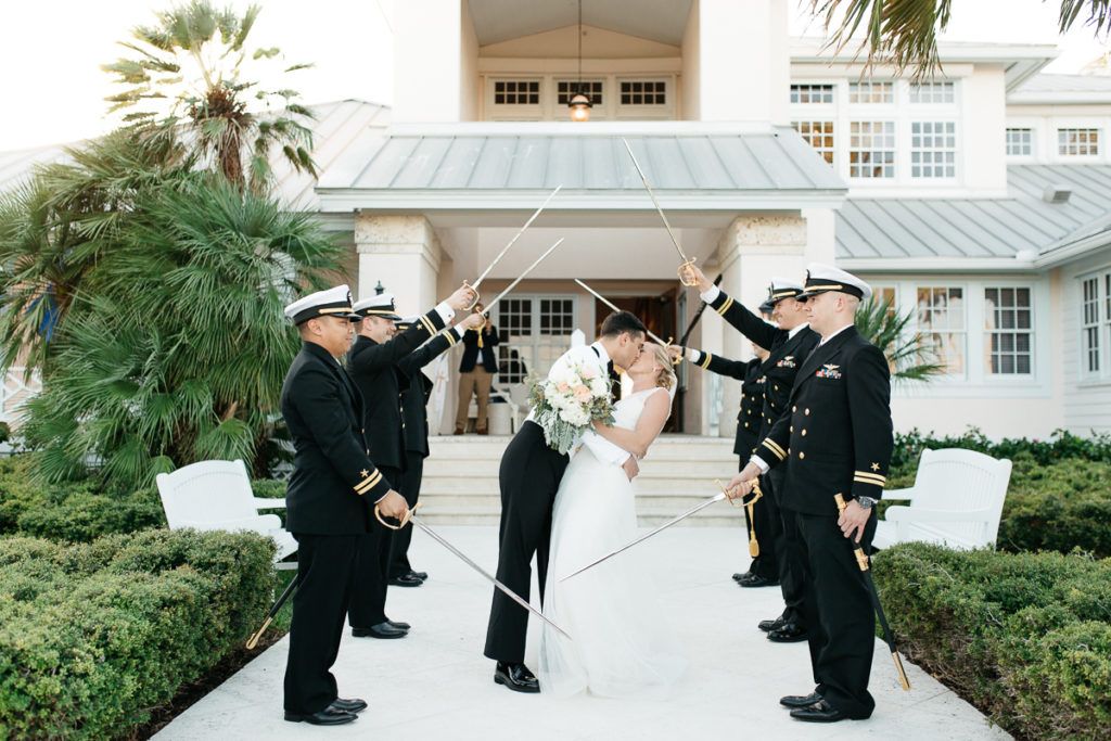 navy sword salute bride and groom kiss at boca bay pass club wedding