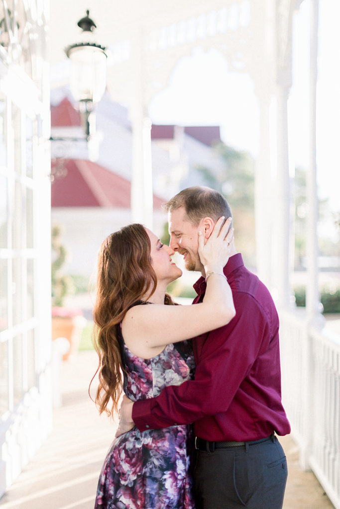 couple kiss at Disney's grand Floridian resort for engagement session photos