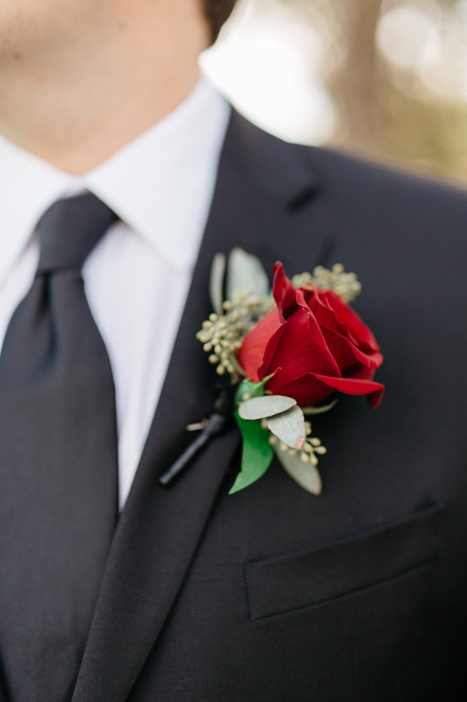 maroon red rose boutonnière 