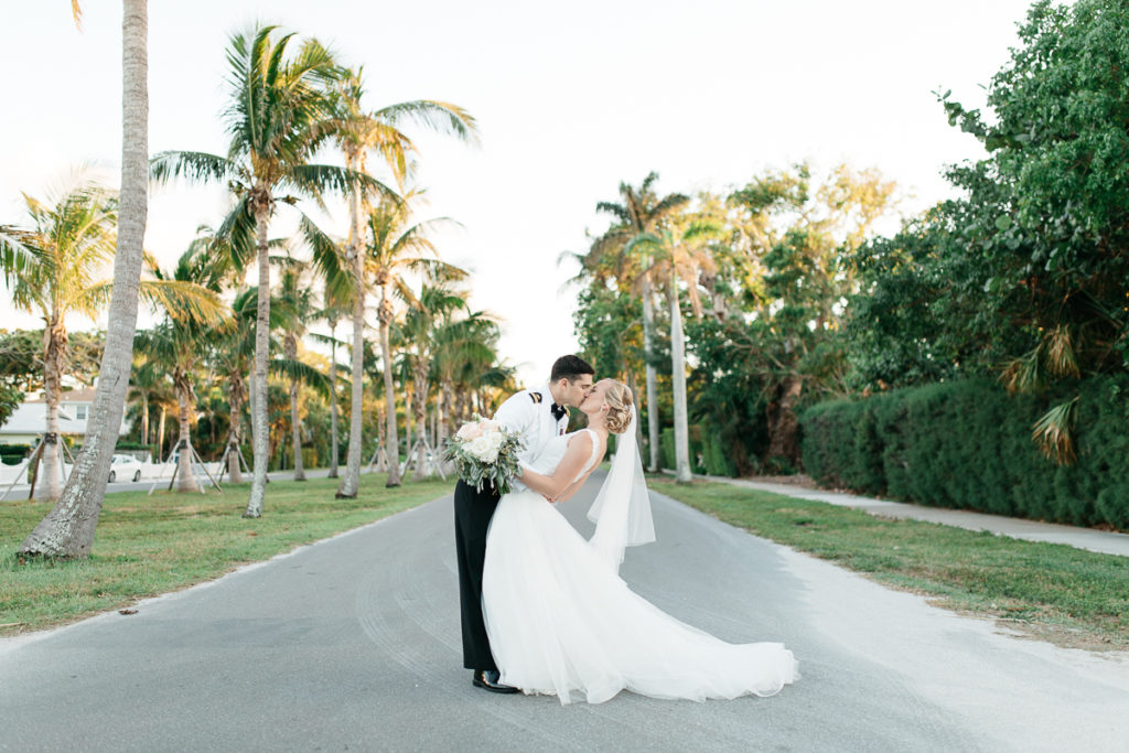 bride and groom kissing on gasparilla island boca bay pass club wedding