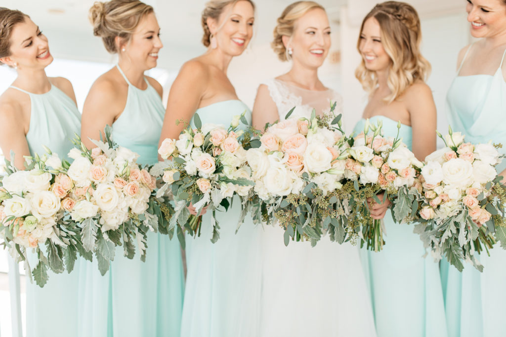 bridesmaids in mint gowns with blush bouquets at boca bay pass cub wedding