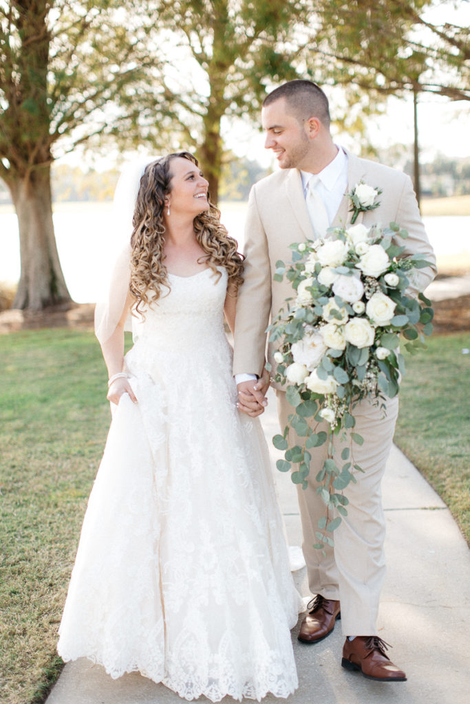 bride and groom walking with cascading bouquet at golden bear club wedding