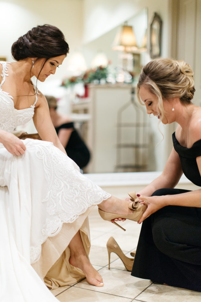 Kirsten getting her beautiful shoes on with her maid of honor in the treasury bridal suite