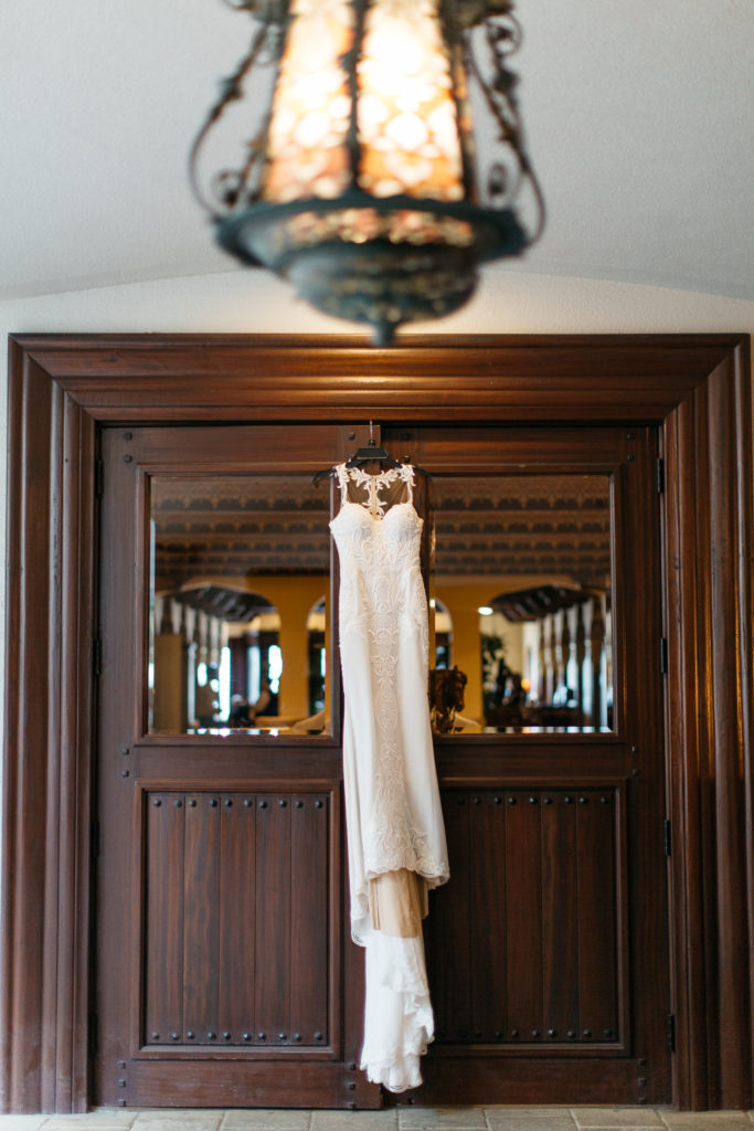 Berta wedding gown from Calvet Couture bridal hanging on the Casa Monica doorway