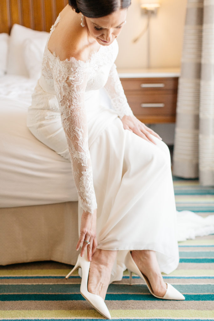 bride putting on j Crew wedding shoes at the alfond inn