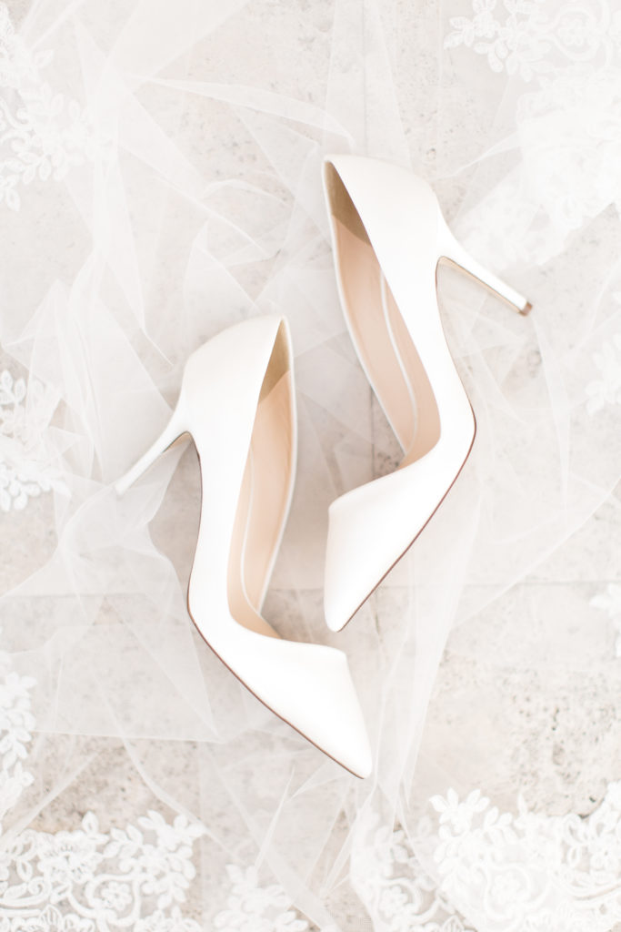 white bridal shoes on long cathedral veil