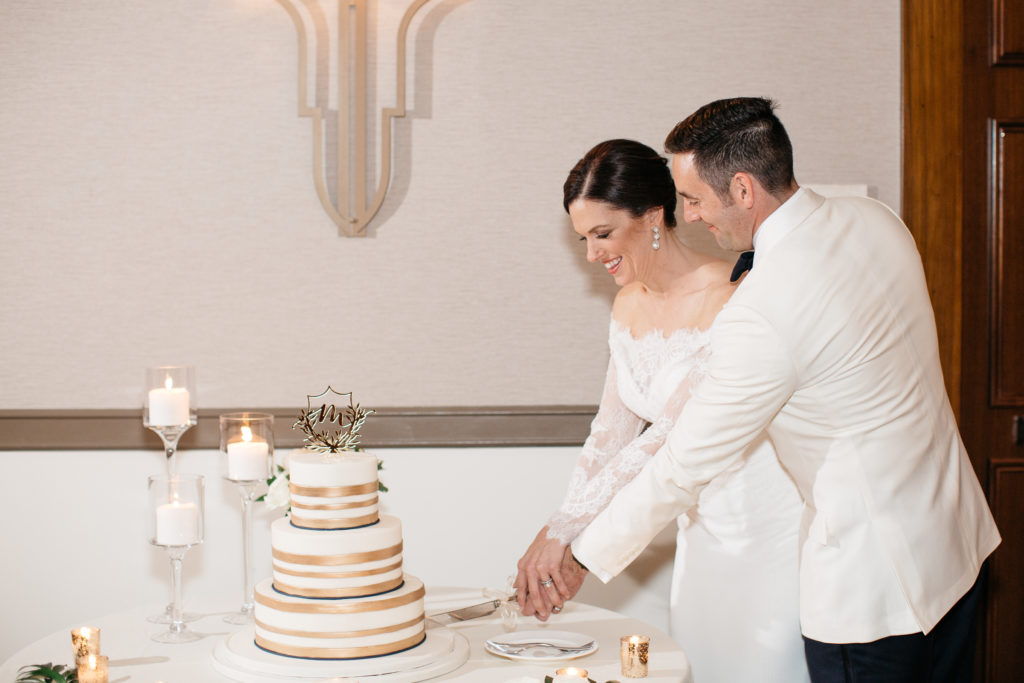 bride and groom cut the cake at the alfond inn wedding