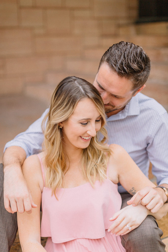 couple sitting on steps of church for Chicago, Illinois engagement session