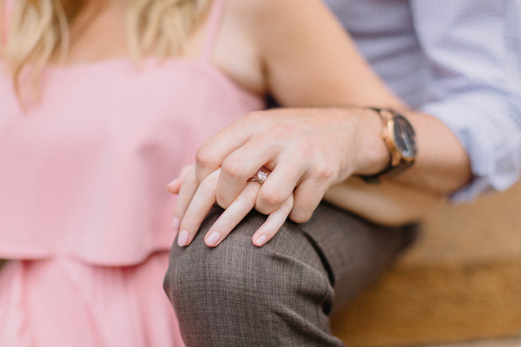 couple holdings hands while sitting on steps for Chicago, Illinois engagement session