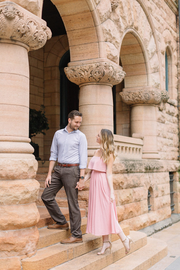 couple walking on steps of church for Chicago, Illinois engagement session