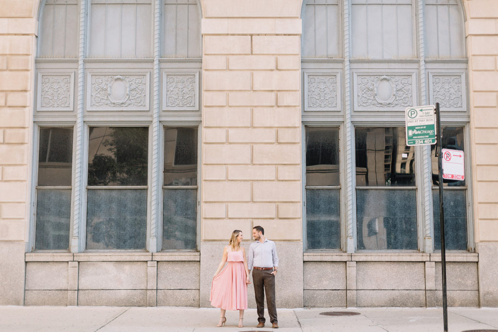 couple standing on the sidewalk side by side for Chicago, Illinois engagement session