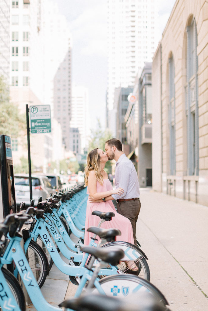 couple sitting on bikes and kissing for Chicago, Illinois engagement session