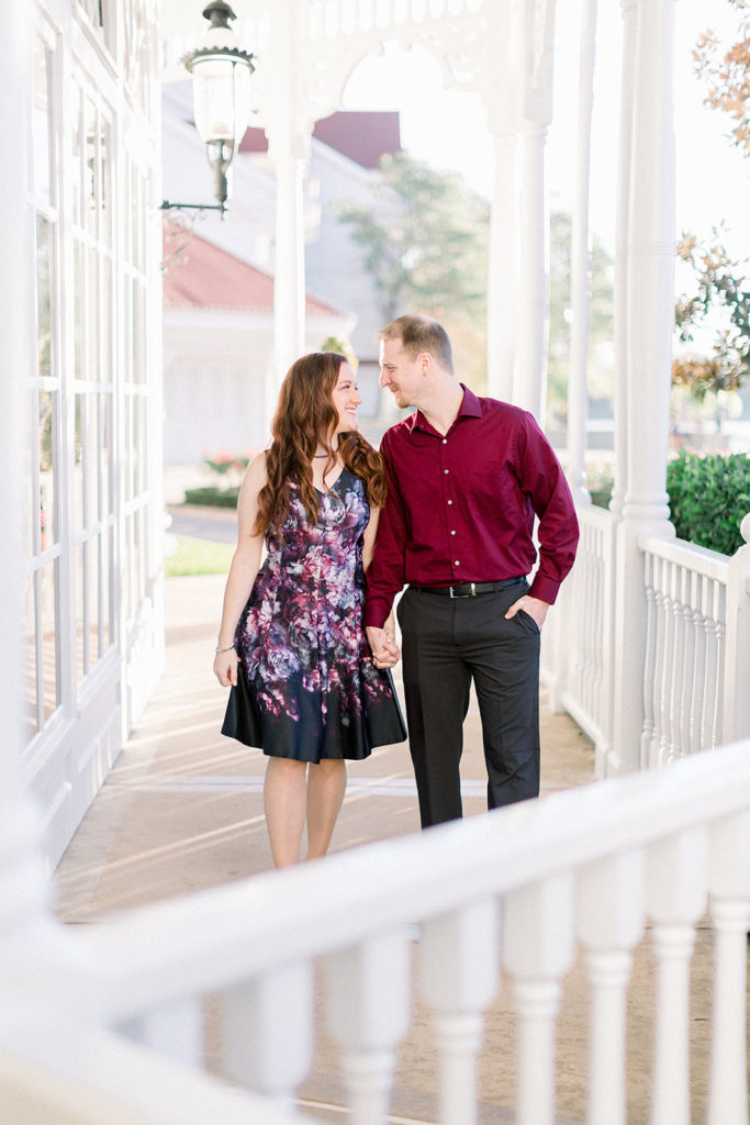 couple take a stroll together at Disney's grand Floridian resort for engagement session photos
