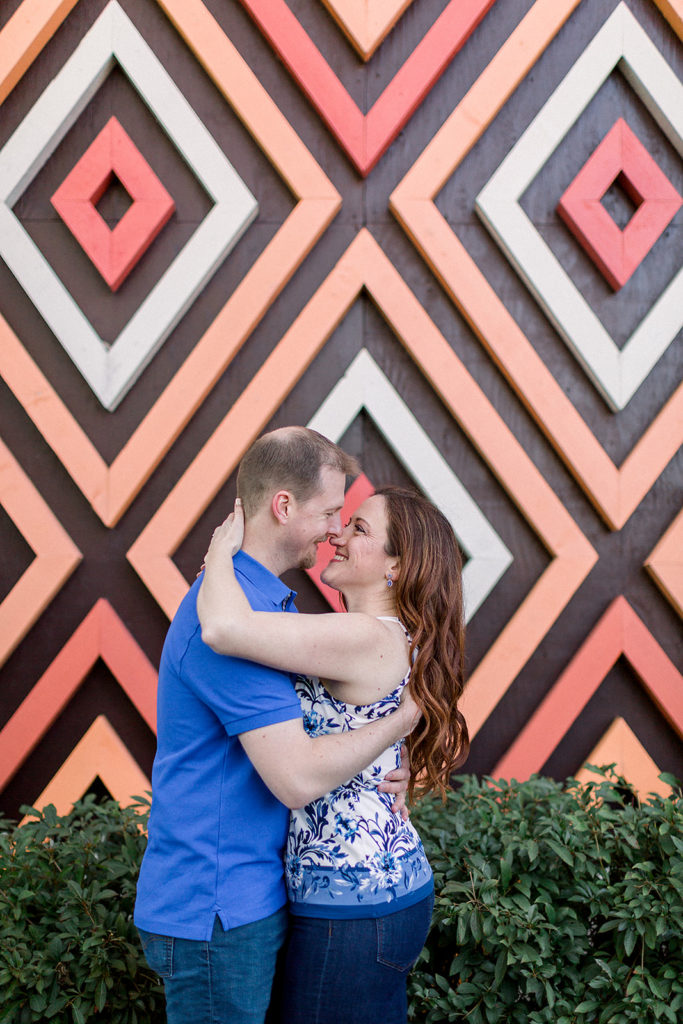 couple embrace at Disney's Polynesian resort for engagement session photos
