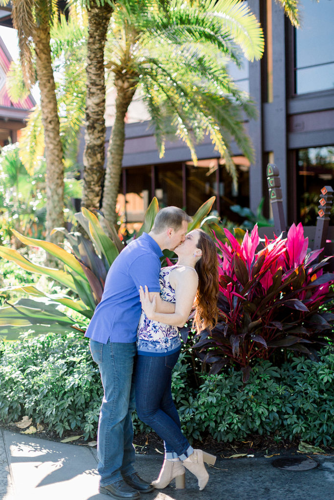 couple embrace at Disney's Polynesian resort for engagement session photos