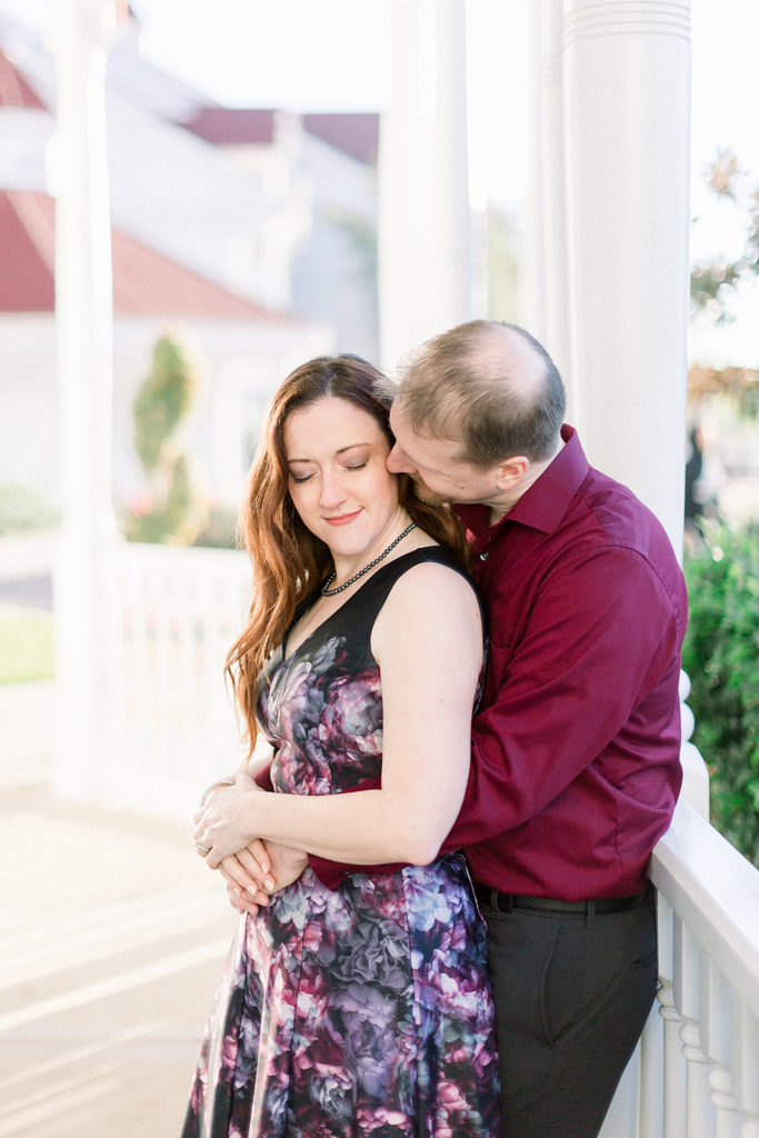 couple hugging at Disney's grand Floridian resort for engagement session photos