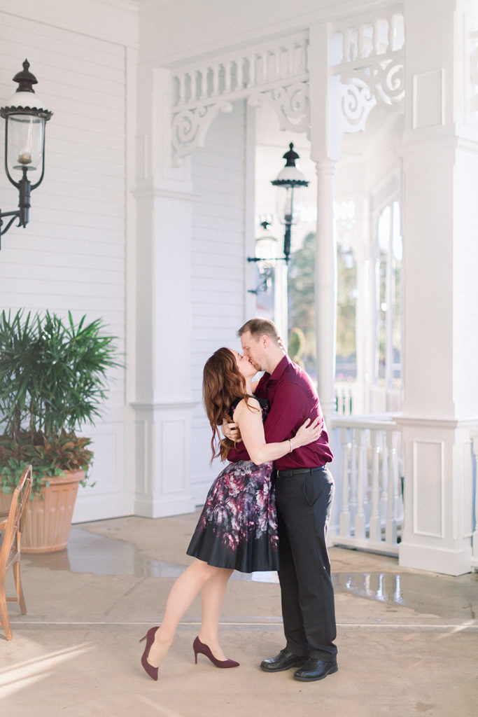 couples romantic kiss at Disney's grand Floridian resort for engagement session photos