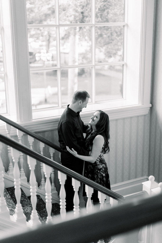 couple embrace at Disney's grand Floridian resort for engagement session photos