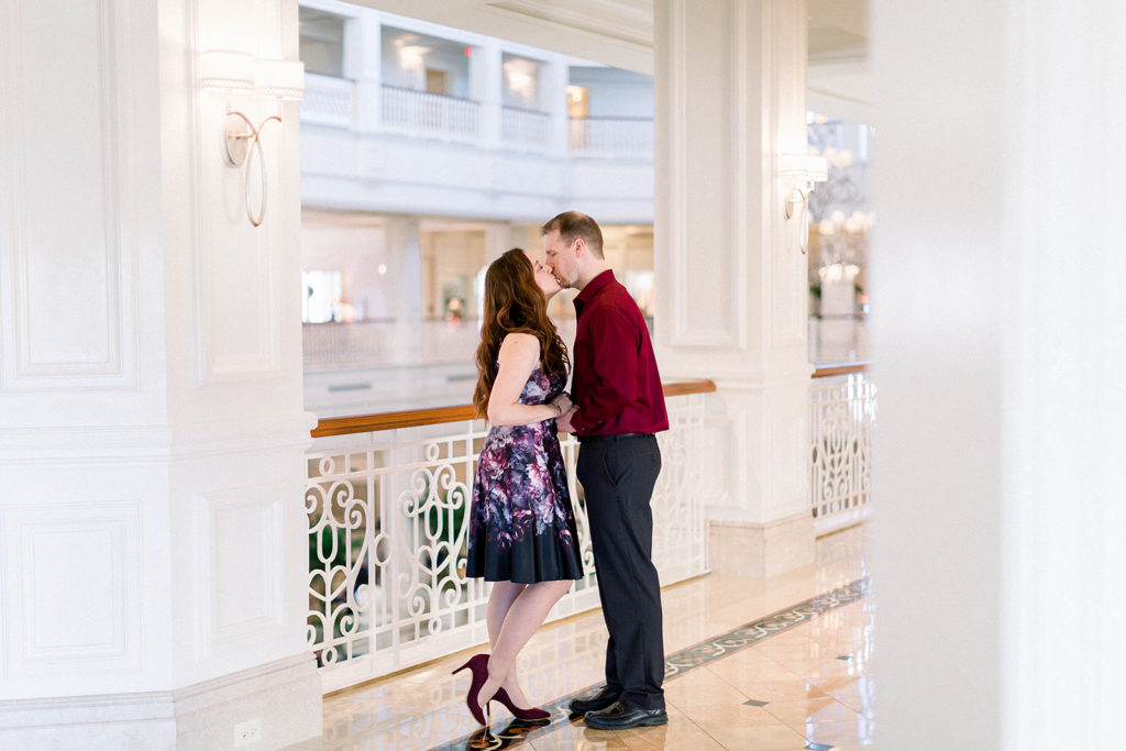 couple embrace at Disney's grand Floridian resort for engagement session photos