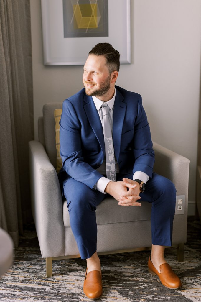 groom portraits sitting in a chair