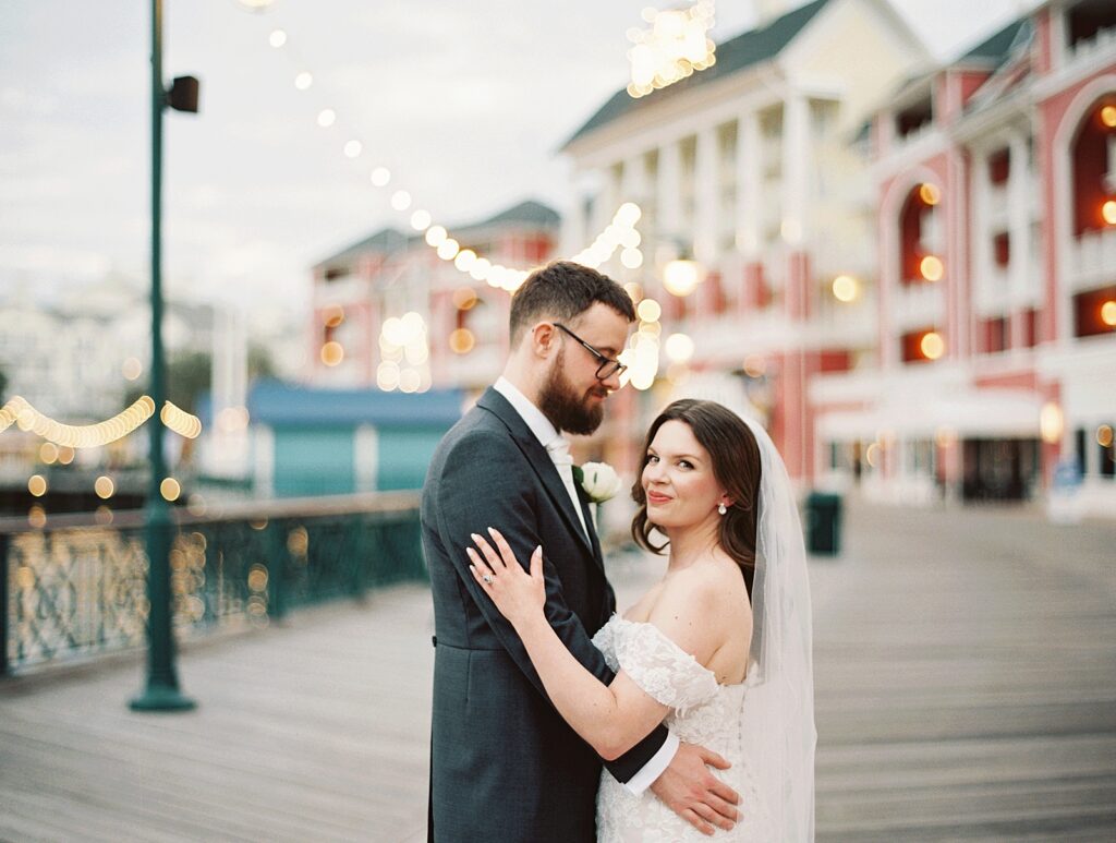 Intimate bride and groom portraits with the market lights at Disneys Boardwalk Resort photographed by disney wedding photographer, Casie Marie Photography
