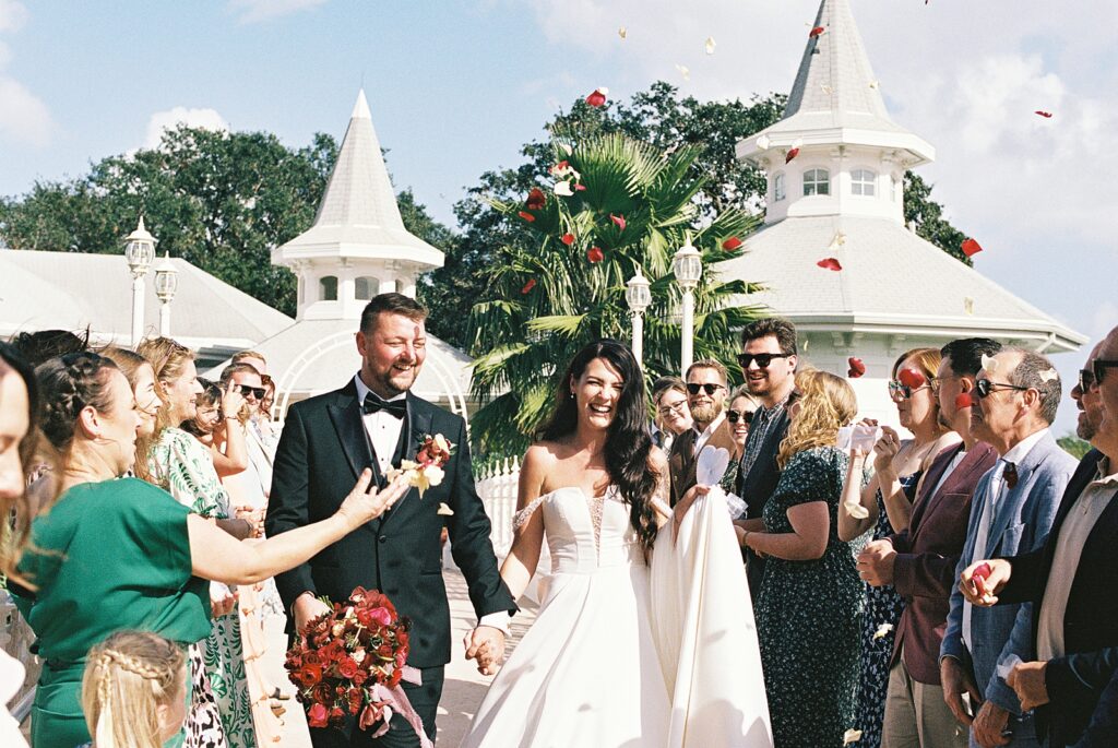 Candid petal toss photos at Disneys Wedding Pavilion captured by Walt Disney World wedding photographer Casie Marie Photography