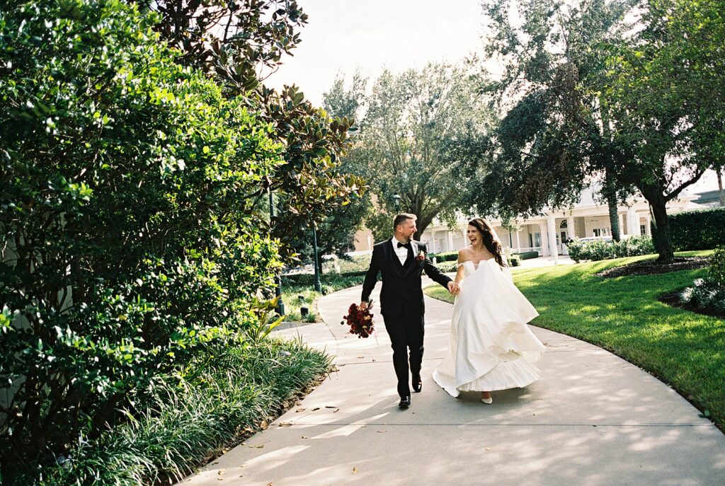 Bride and groom on their way to cocktail hour at Disneys Grand Floridian, captured by Walt Disney World wedding photographer Casie Marie Photography