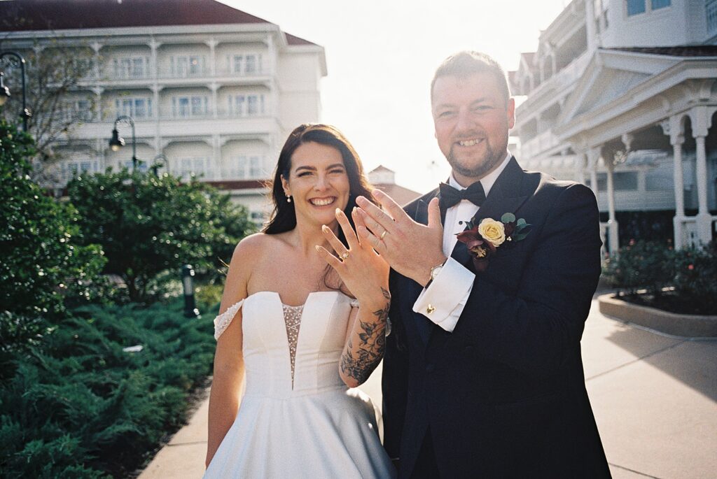 Bride and groom on their way to cocktail hour at Disneys Grand Floridian, captured by Walt Disney World wedding photographer Casie Marie Photography