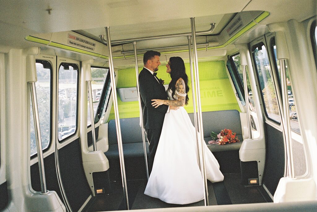 Bride and Groom photos on the monorail to their reception captured by Walt Disney World wedding photographer Casie Marie Photography