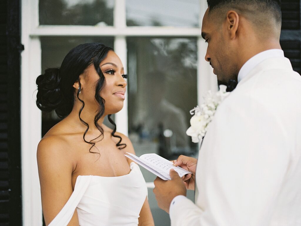 first look on the front porch of the Merrimon-Wynne house wedding photographed by Casie Marie Photography