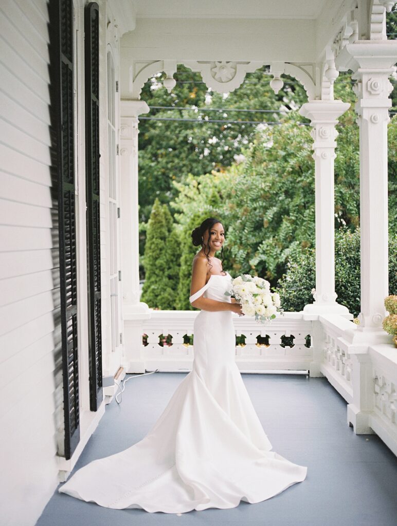 bridal portraits on the porch at Merrimon-Wynne house wedding photographed by Casie Marie Photography